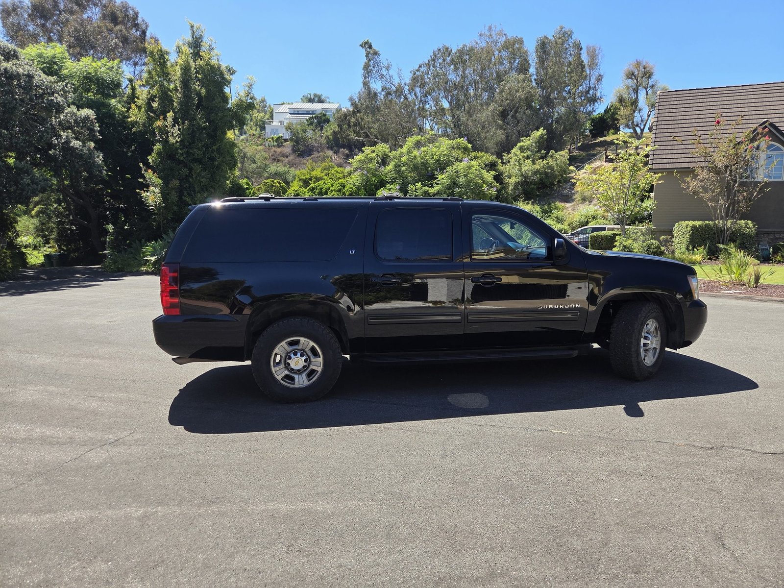 Black 2010 Chevrolet Suburban in profile